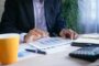 Dividend income mortgage expat - business director reviewing financial documents