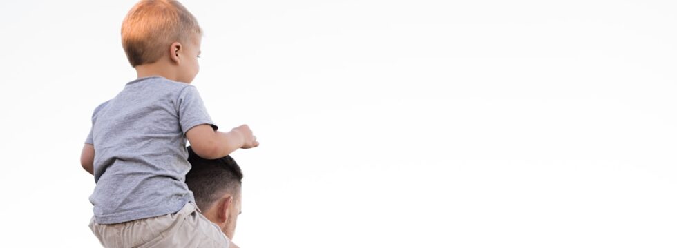 Expat Critical Illness Cover - Family Financial Protection Father carrying child on shoulders representing family financial protection through critical illness cover for expats