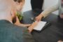 Guarantor mortgage vs JBSP - family signing mortgage documents together