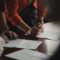 Joint tenants vs tenants in common - couple signing property ownership documents