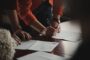Joint tenants vs tenants in common - couple signing property ownership documents