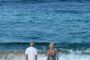 Selling UK property retirement abroad - elderly couple watching sunset on beach