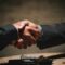 Buying a business with property UK - handshake business agreement