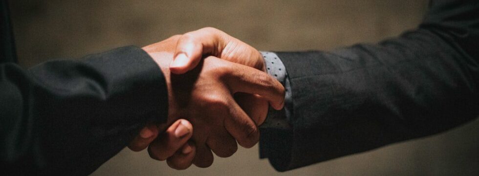 Buying Business That Comes With Property Buying a business with property UK - handshake business agreement