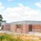 Development finance cost overrun UK - half-built house construction site