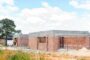 Development finance cost overrun UK - half-built house construction site