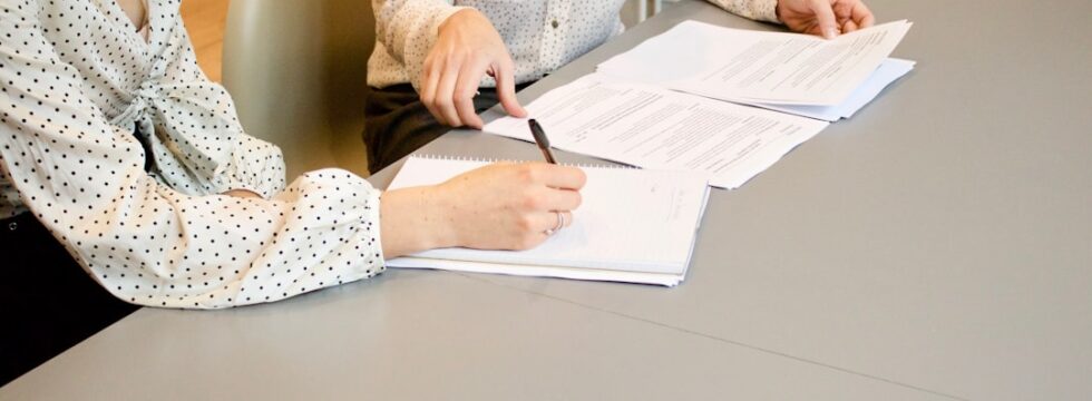 JBSP mortgage UK - two people signing joint mortgage documents
