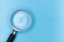 Regulated vs unregulated bridging UK - magnifying glass reviewing documents